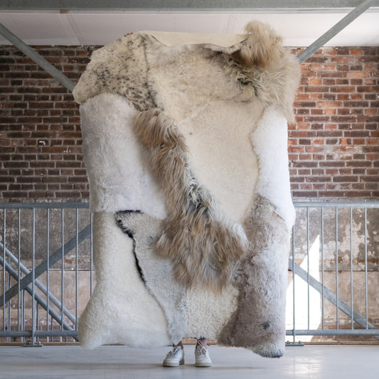 Full view of the different colors and textures of the cream melange sheepskin