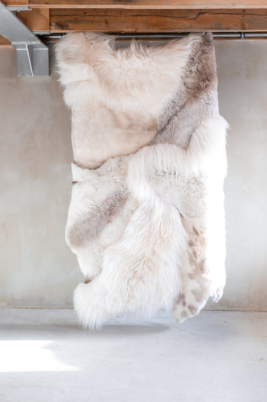 Full view of the different colors and textures of the cream melange sheepskin
