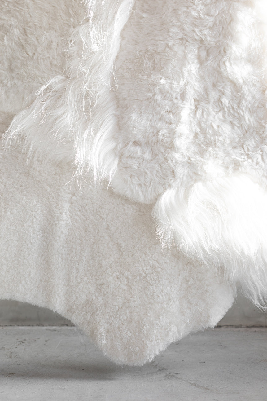 Closeup view of the different colors and textures of the white melange sheepskin