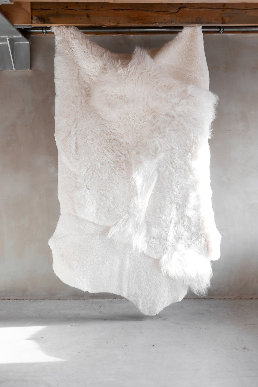 Full view of the different colors and textures of the white melange sheepskin